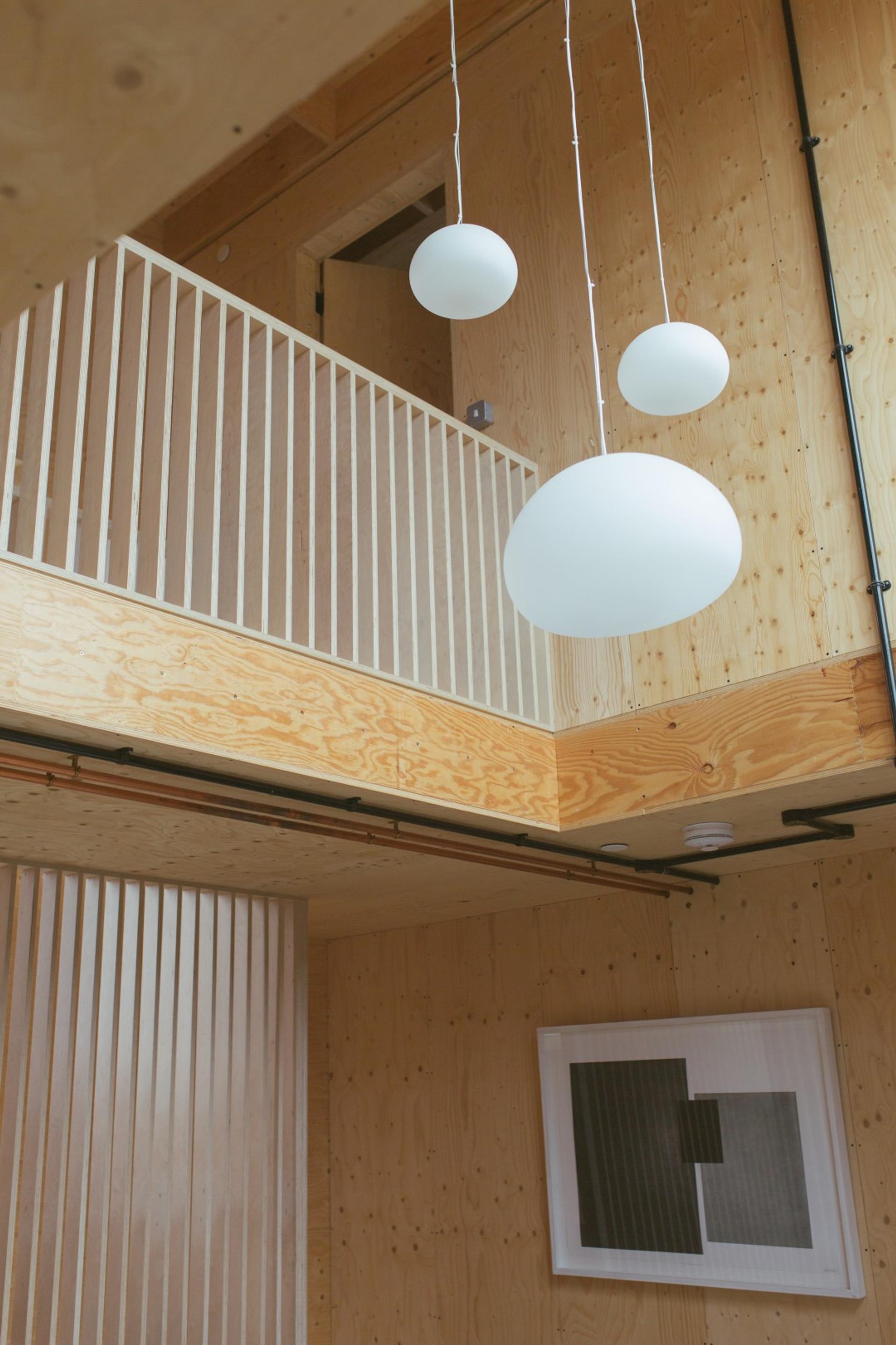 This is an interior gallery and dining room photograph of Box House. It is made of U-Build in collaboration with Studio Bark and has been featured on the Grand Designs TV show.