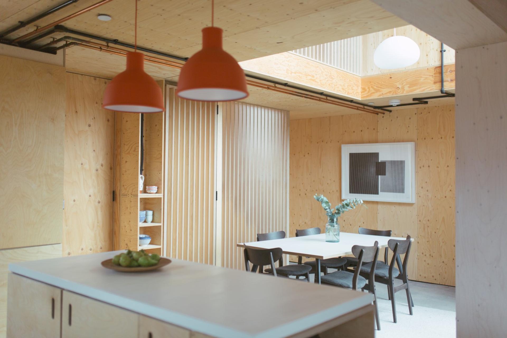 This is an interior dining room photograph of Box House. It is made of U-Build in collaboration with Studio Bark and has been featured on the Grand Designs TV show.