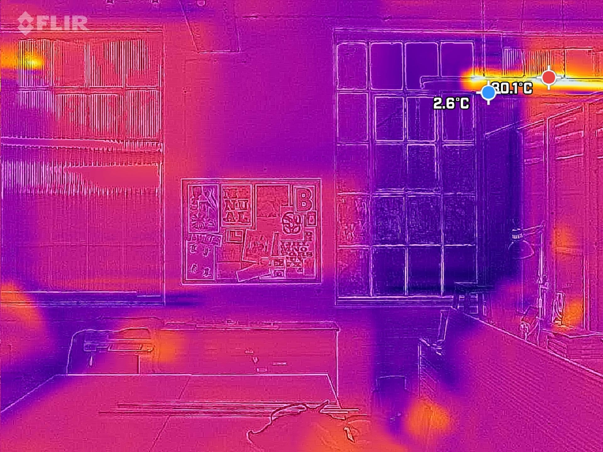 A thermal image of a Spruce modular classroom reveals cool temperatures near the windows, with one window corner at 0.1°C and 2.6°C. Warmer spots are visible on desks and surfaces, highlighting a focus on sustainable design.