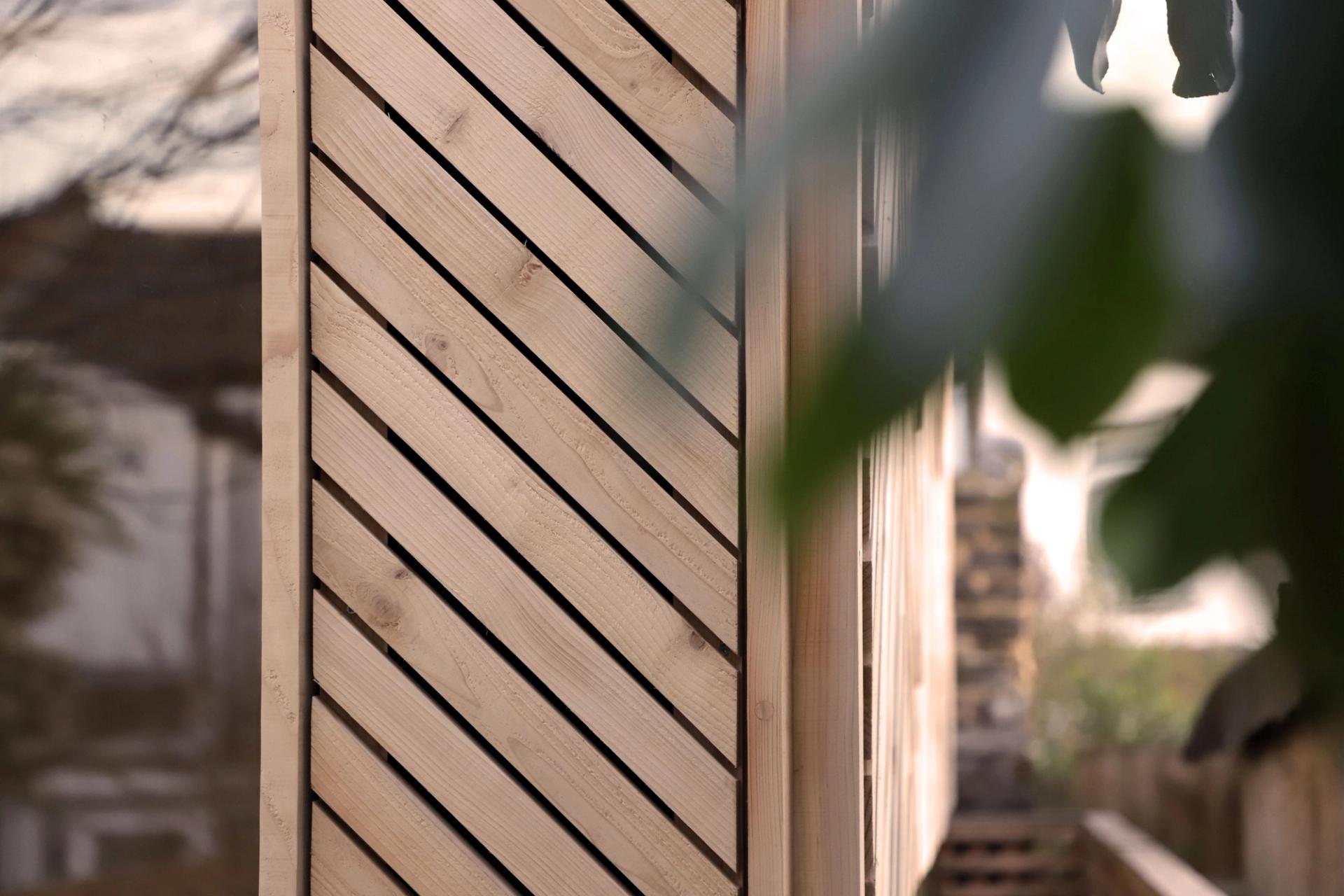 A detail exterior photograph of the western red cedar cladding for a garden room in an East London garden