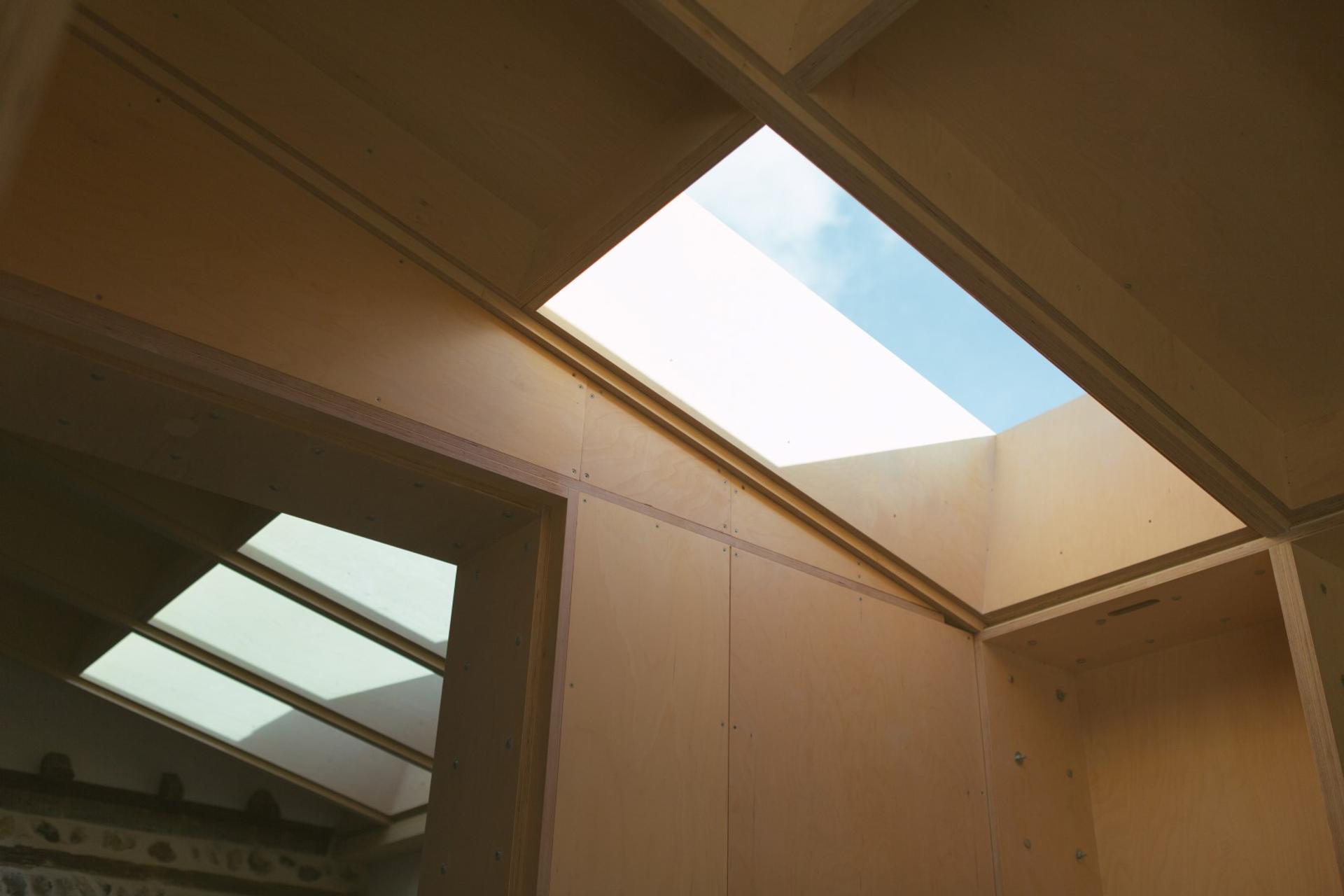 Bespoke wooden roof with skylight in a bespoke house