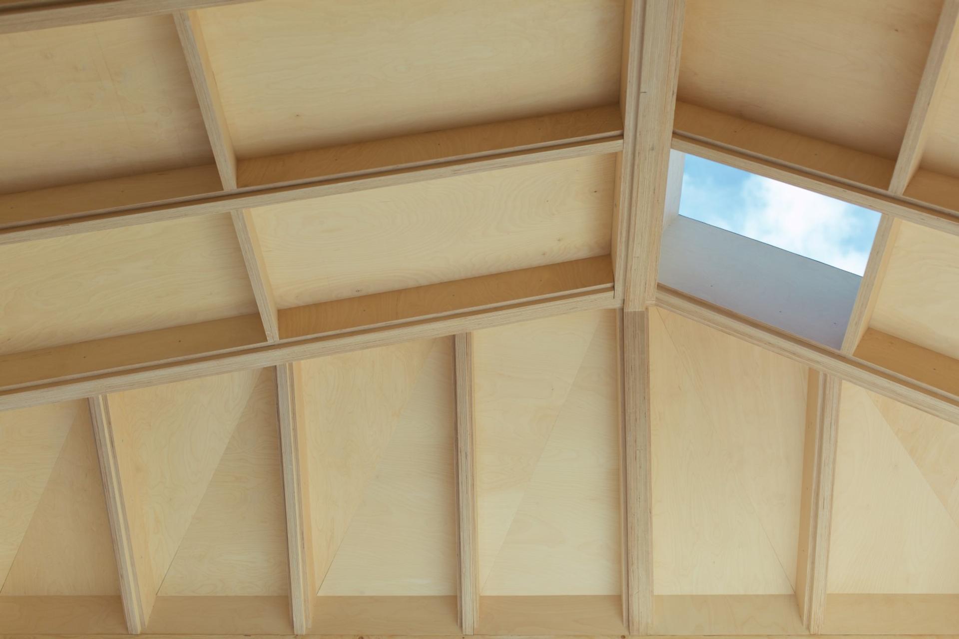 A bespoke wooden vaulted roof with skylights