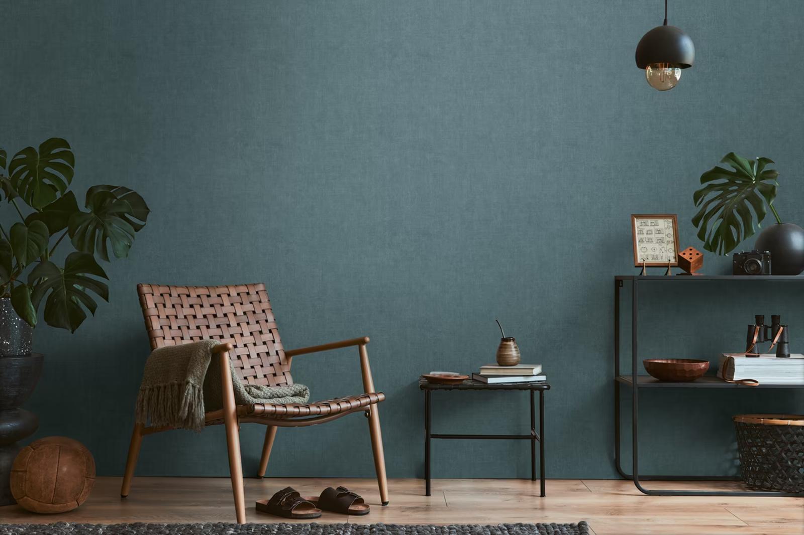 Teal Linen wallpaper behind a woven leather chair