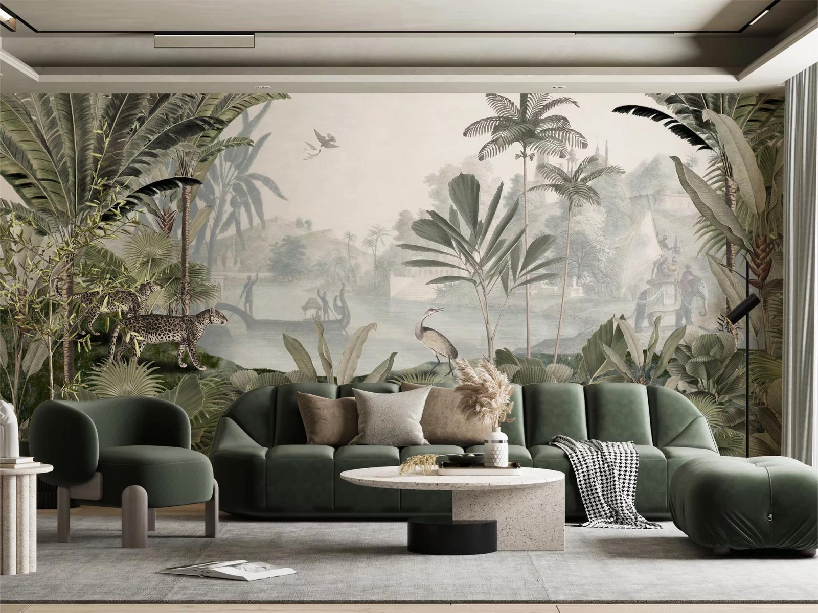 A tropical scenic mural with palms, a leopard and a heron behind a deep green velvet sofa and a terrazzo table