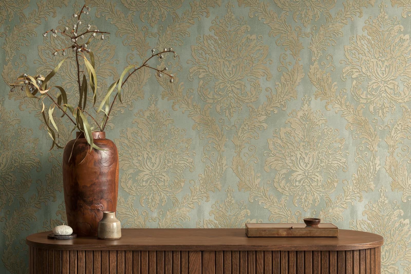 Sage and gold Damask wallpaper above a walnut console