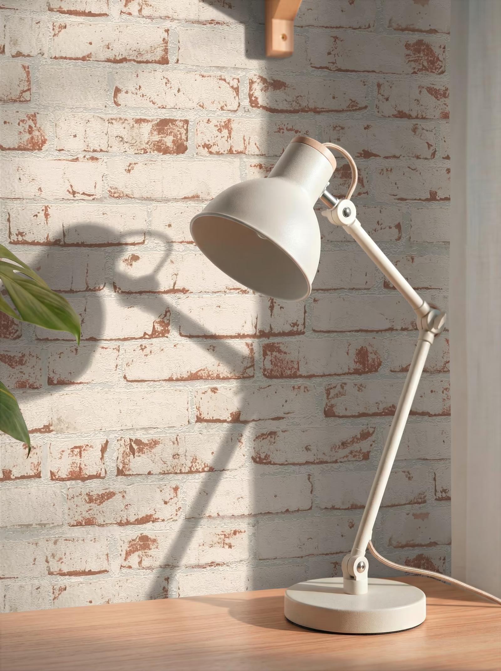 Rustic Brick wallpaper lit by an angled desk lamp