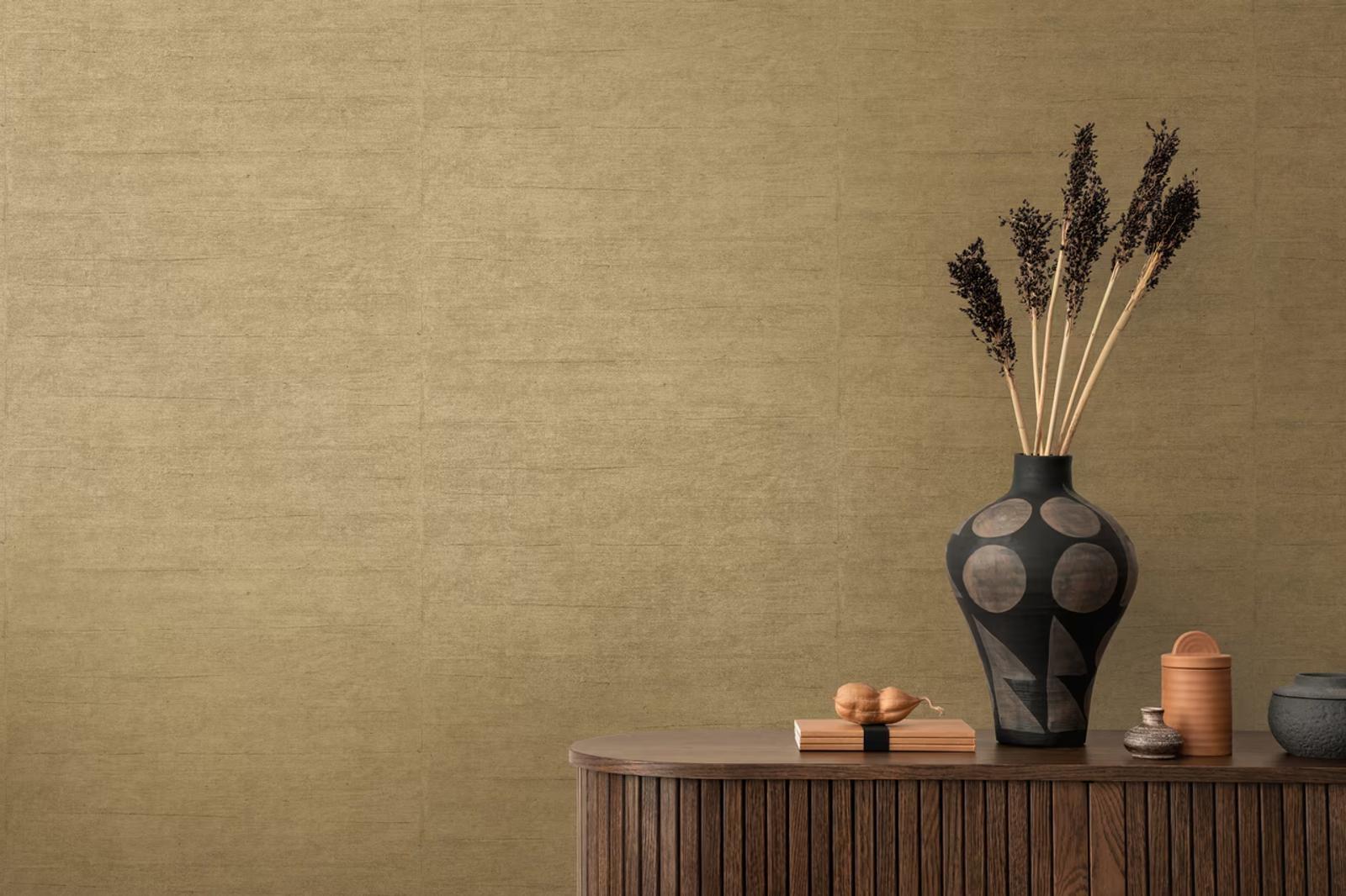 Gold Silk wallpaper above a rounded fluted sideboard