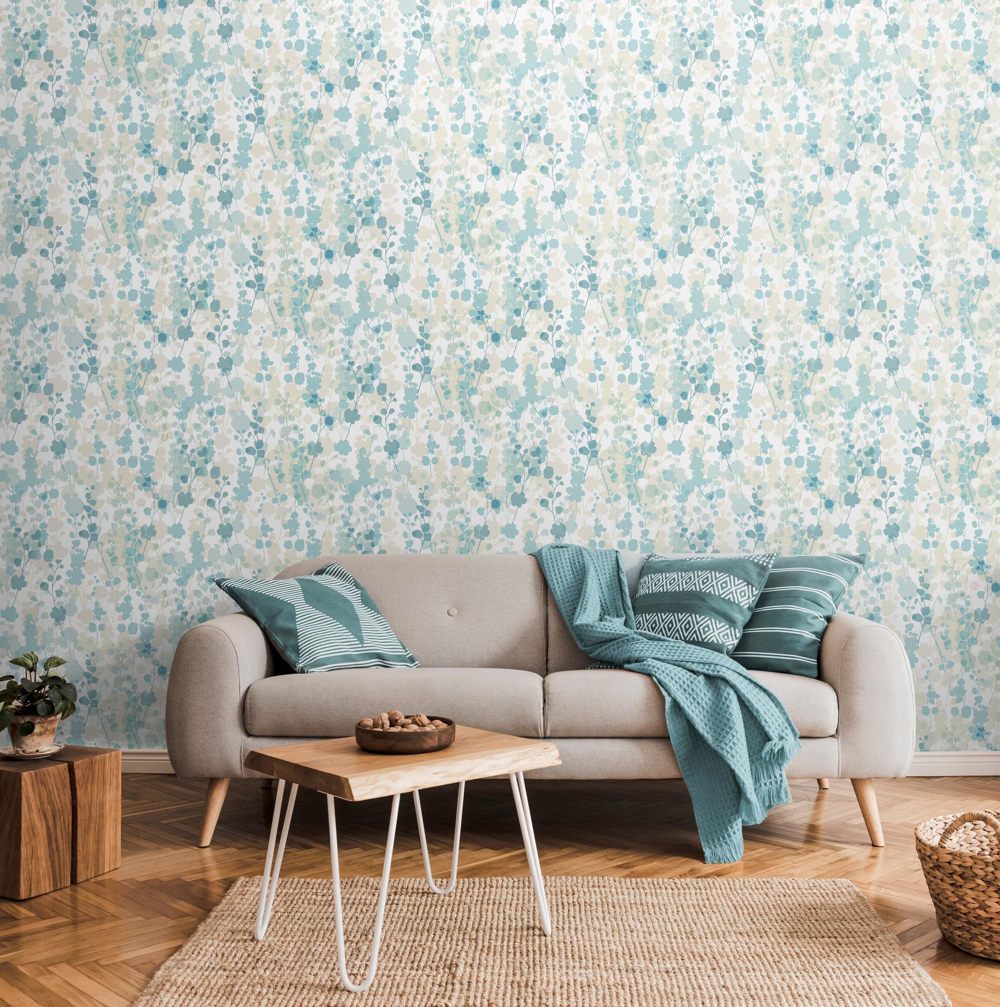 OHPOPSI Laid Bare Blossom Seascape wallpaper behind a sofa in a bright living room — Whiterose Design