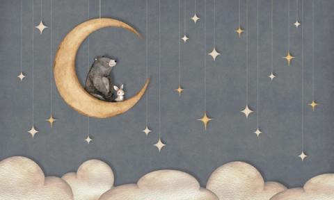 A bear and a small rabbit share a crescent moon beneath hanging paper stars.