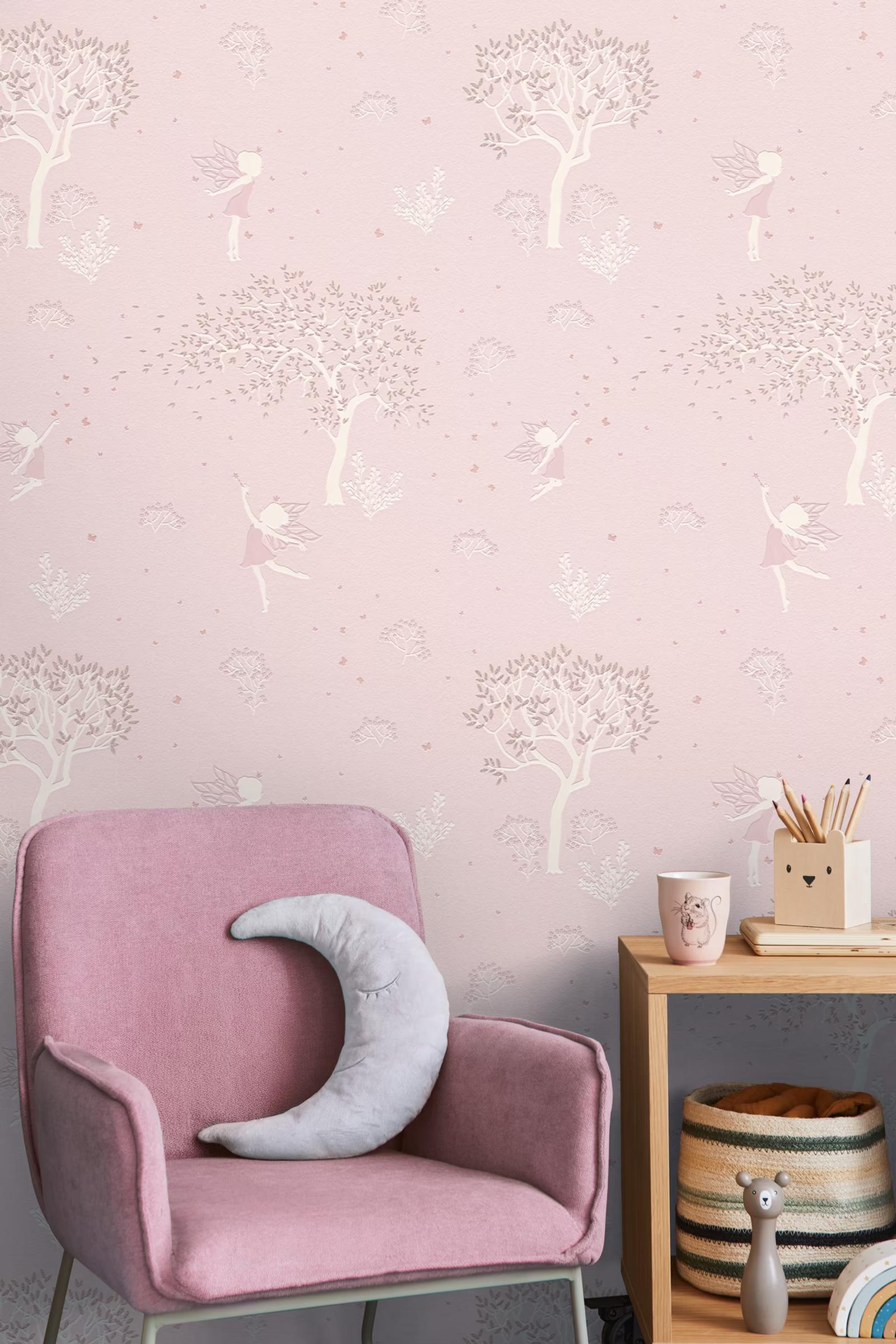 Rose Fairy Wood wallpaper behind a pink armchair with a moon cushion