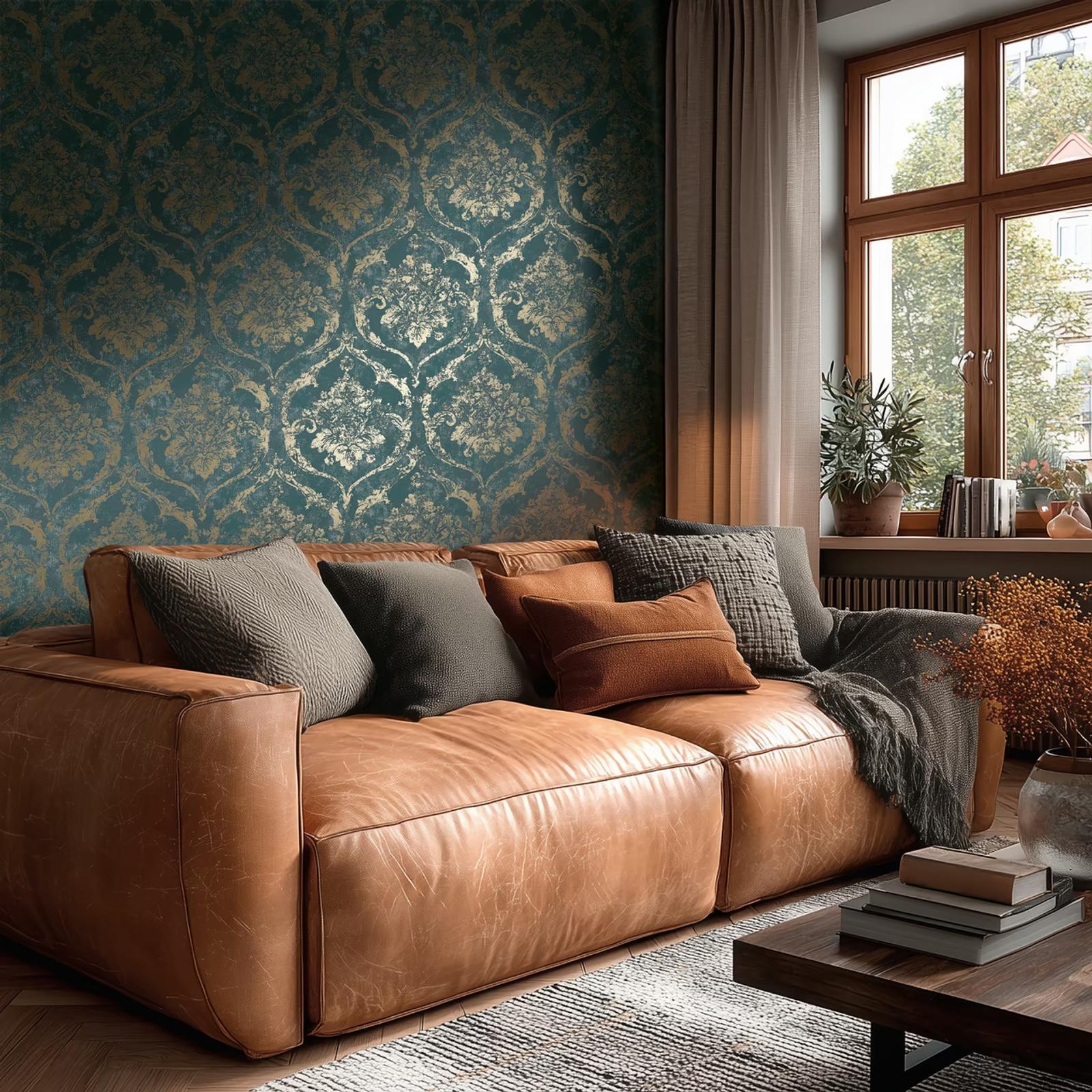 Verdigris Damask wallpaper behind a tan leather sofa