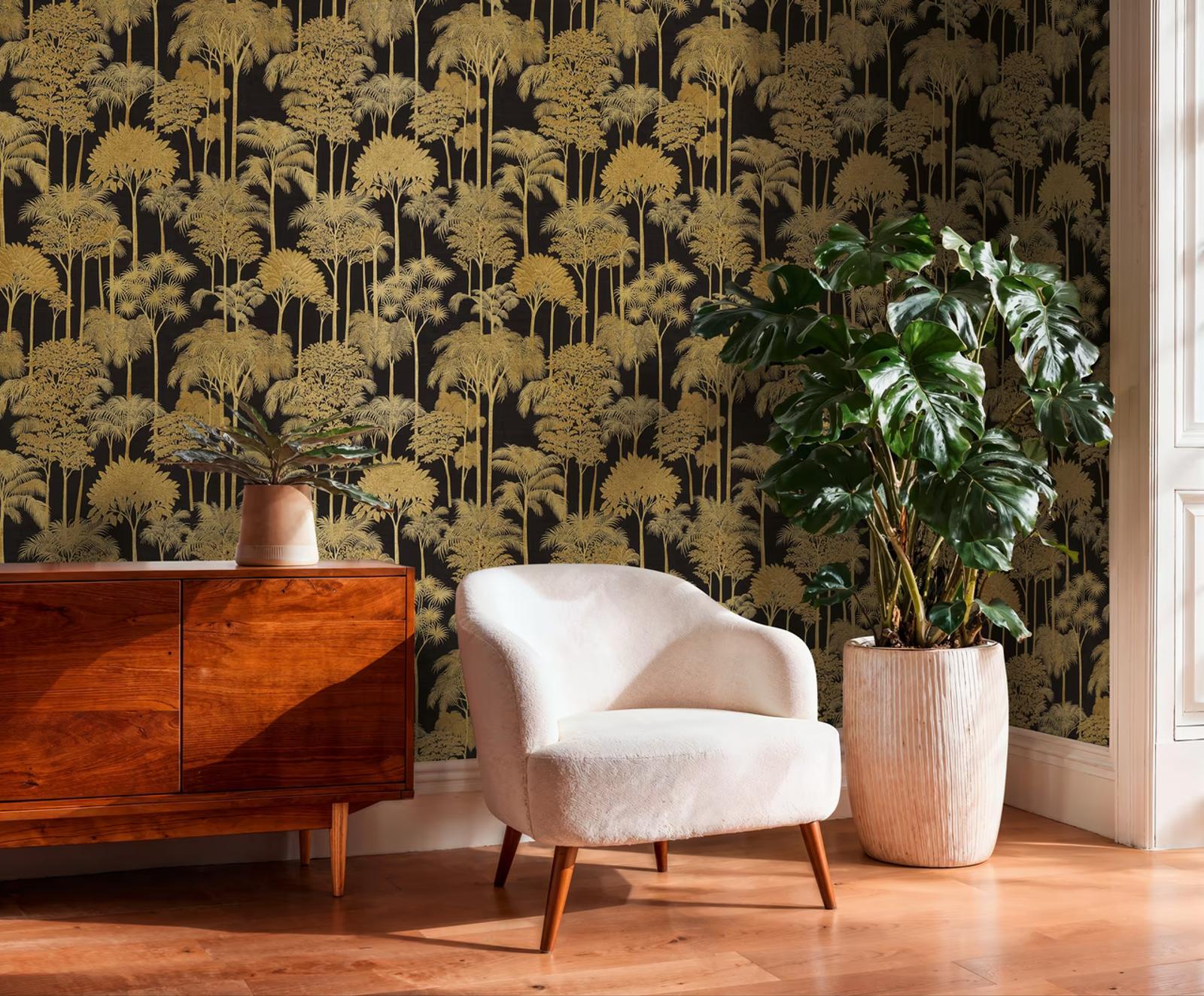 Gold Rainforest wallpaper on black behind a walnut sideboard and monstera