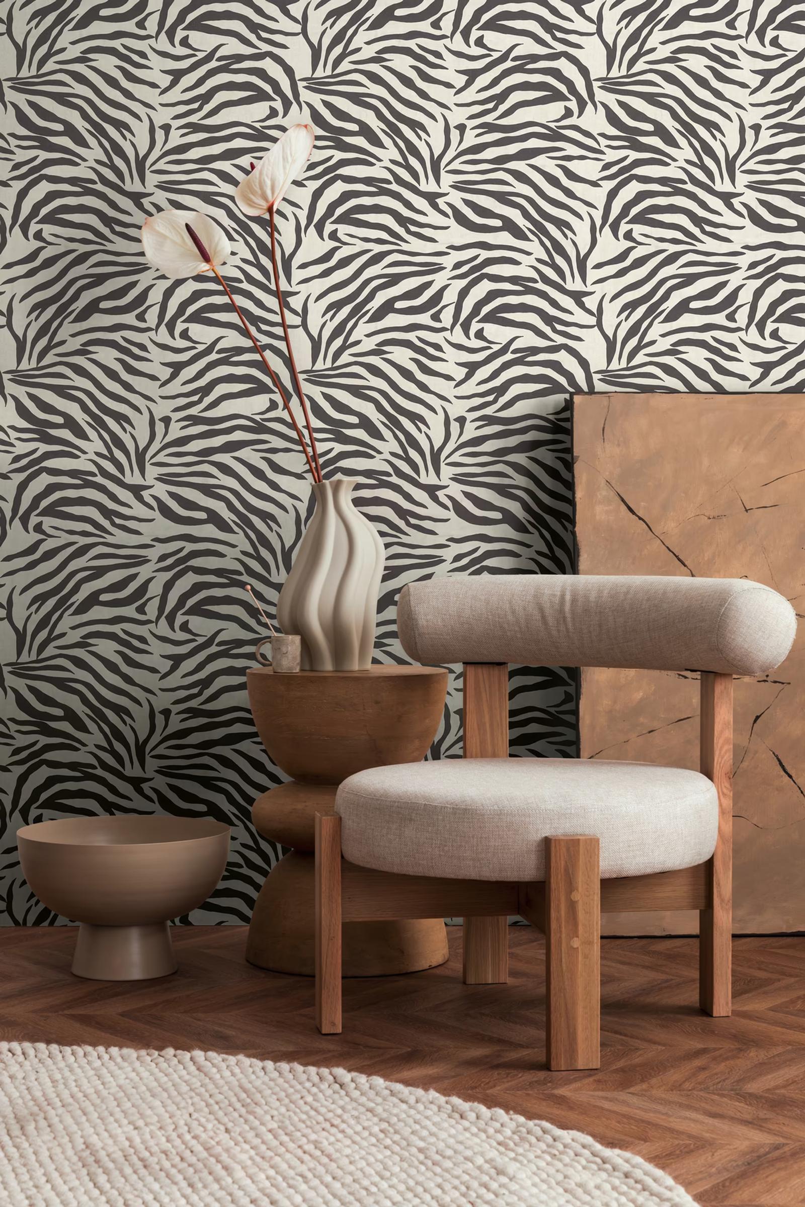 Cream Zebra wallpaper behind a pale wooden tub chair
