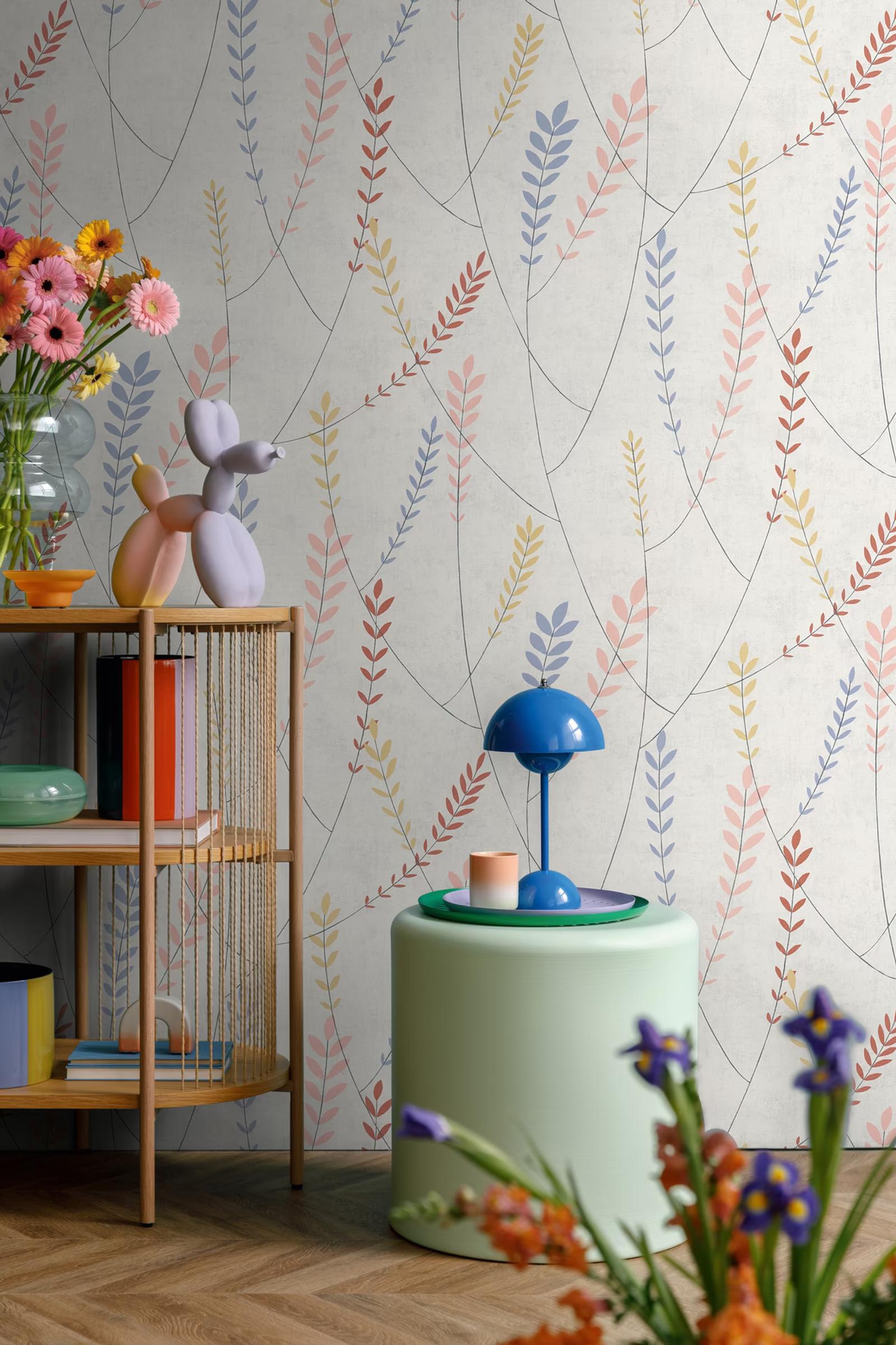 Meadow Sprig wallpaper beside an open shelf of books and a mint side table