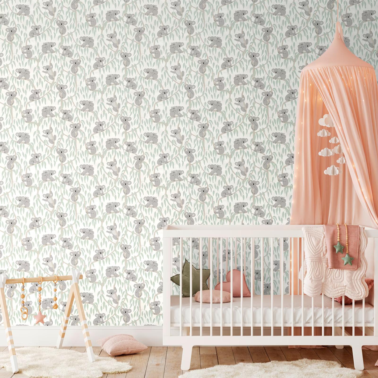 Cream Koala wallpaper in a nursery with a cot and peach canopy