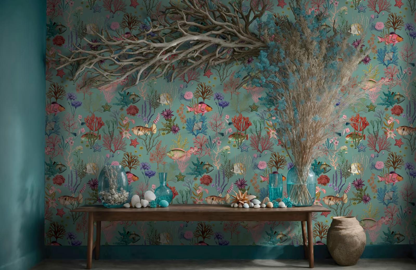 Cora Soft Aqua coral wallpaper behind a wooden console with glass vases