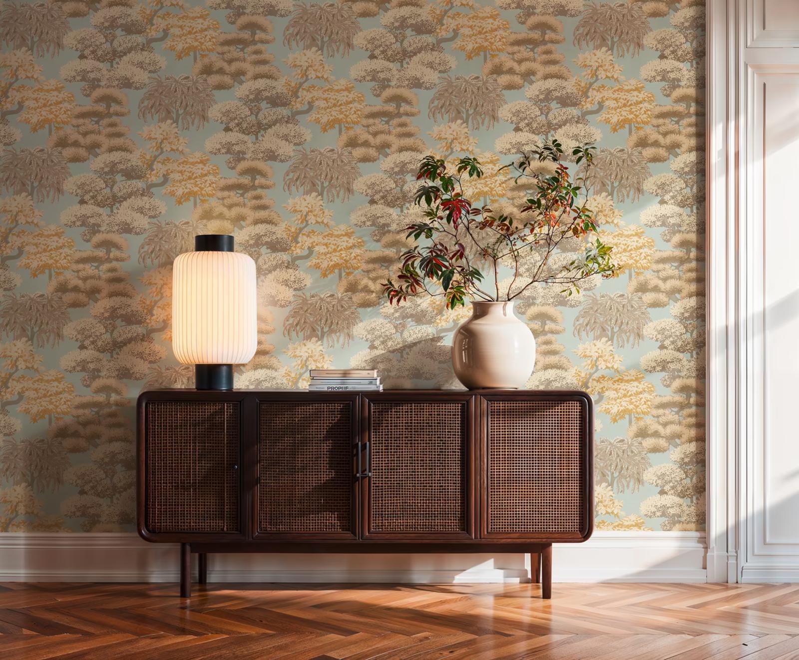 Azure Grove wallpaper in soft blue and gold above a cane sideboard