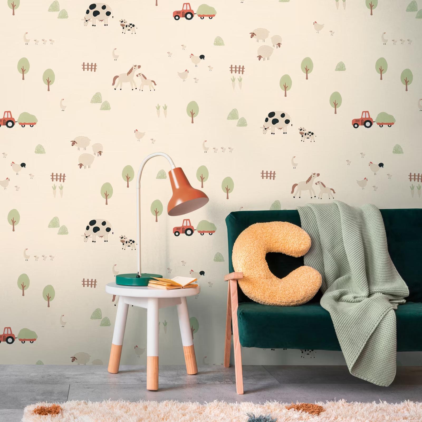 Cream Farmyard wallpaper behind a green velvet sofa