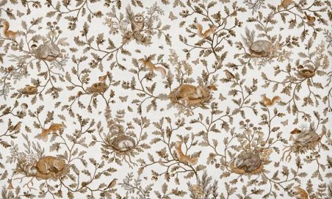 Woodland animals — rabbits, foxes and birds — dotted through leaves and berries in a fine all-over pattern. Shown in a softened vintage white palette. Warm and storybook, it is a wall a child grows into.