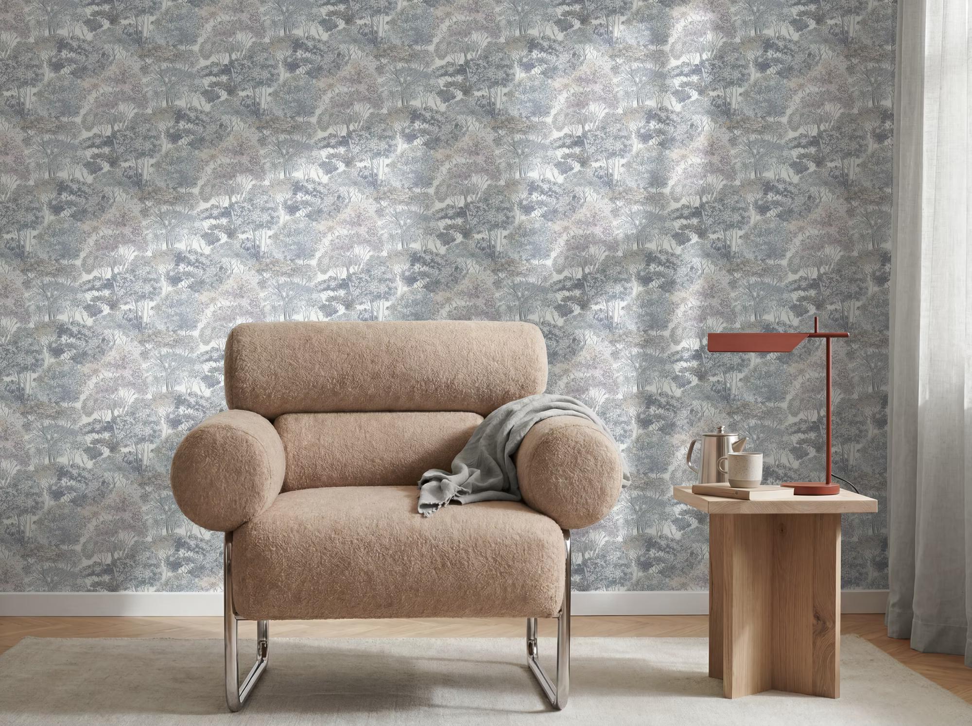 AS Création The Trend Spectrum Blue Forest II wallpaper behind a bouclé armchair — Whiterose Design
