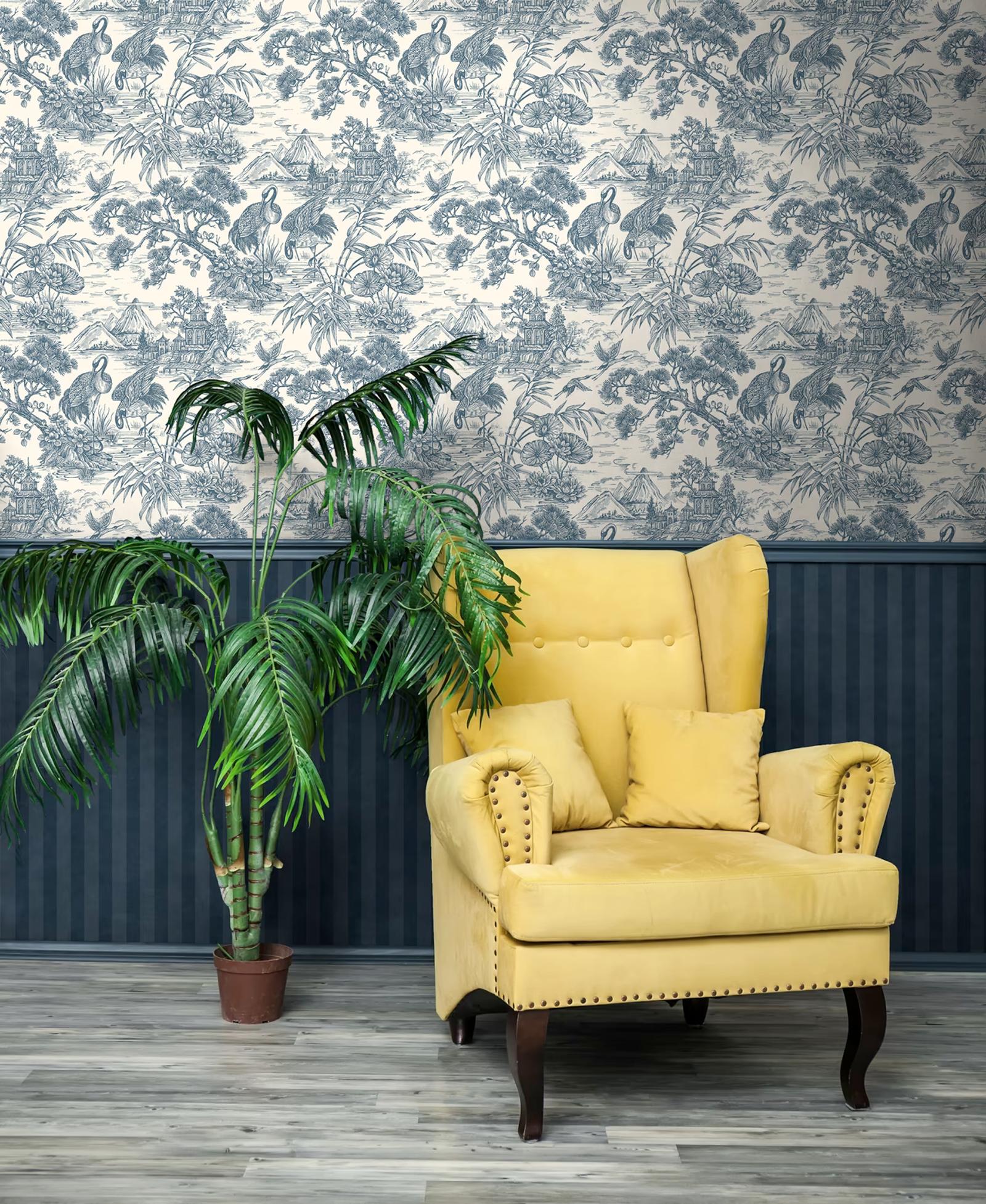 Natoru Navy Cream crane toile wallpaper above a navy dado with a yellow armchair