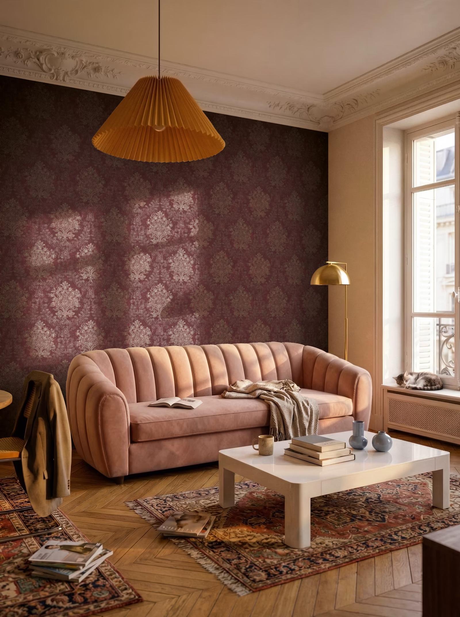 Red Baroque damask wallpaper behind a pink velvet sofa