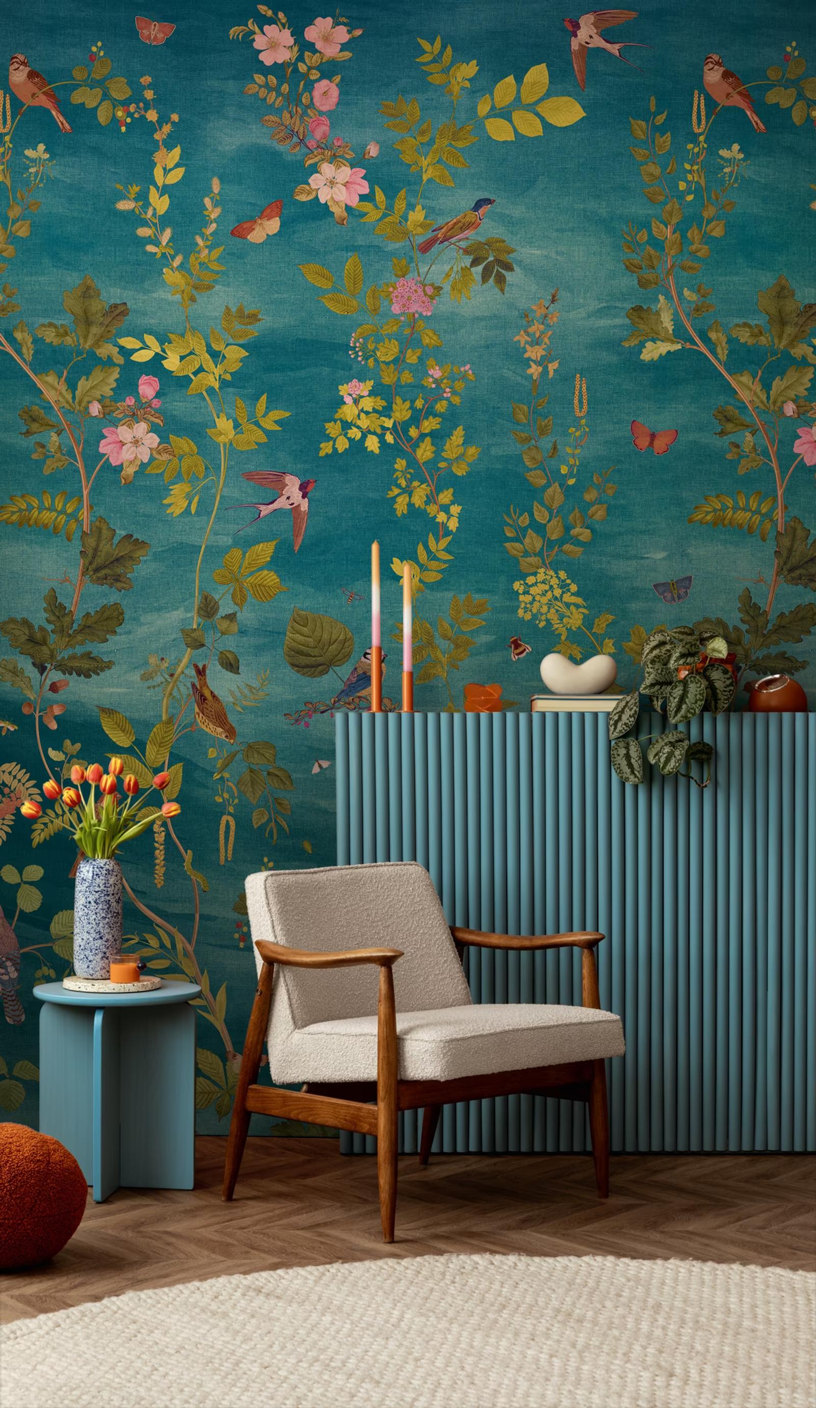 Teal Aviary design panel behind a fluted console and mid-century armchair