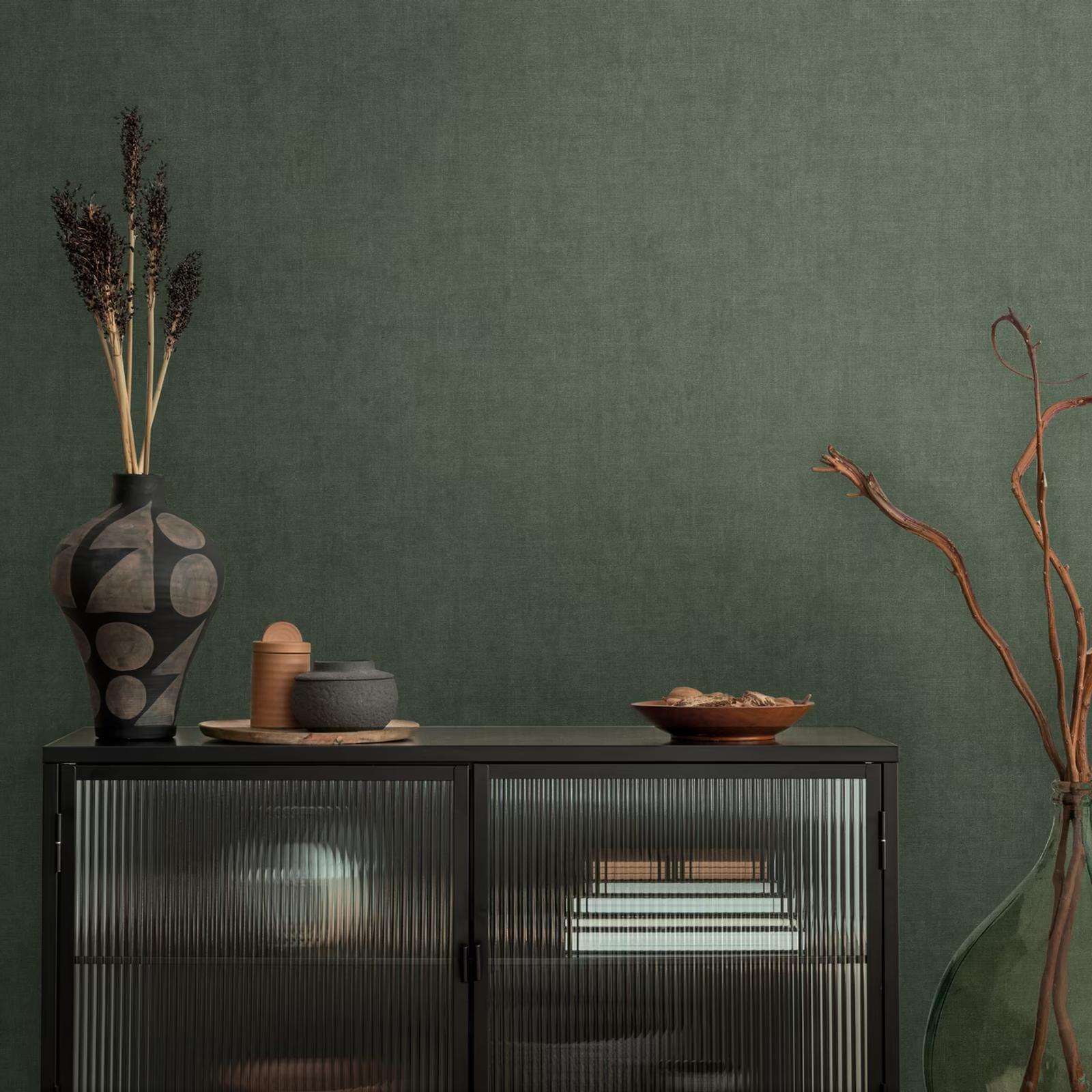 Forest Linen wallpaper behind a black glazed display cabinet