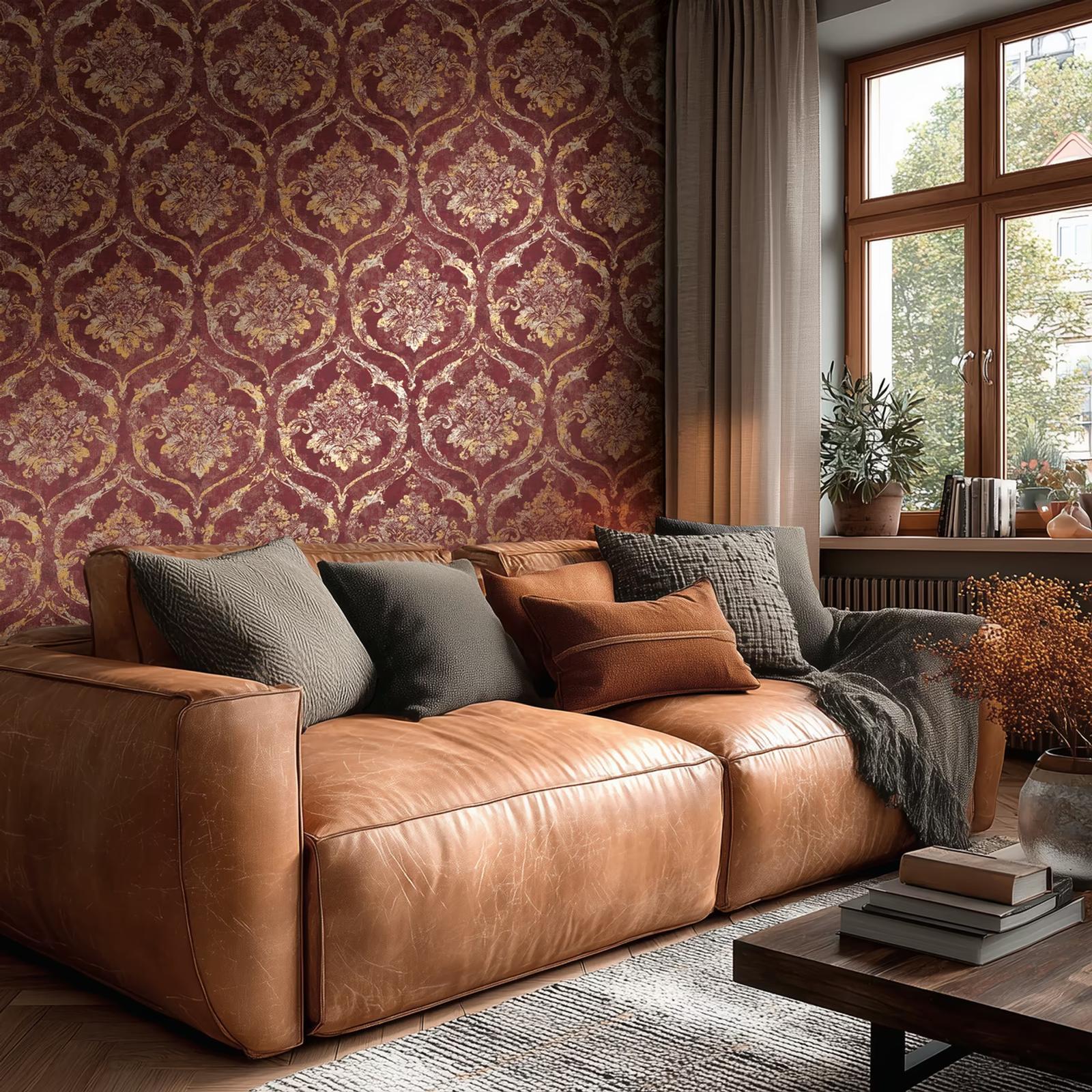 Ruby Damask wallpaper behind a tan leather sofa by a window