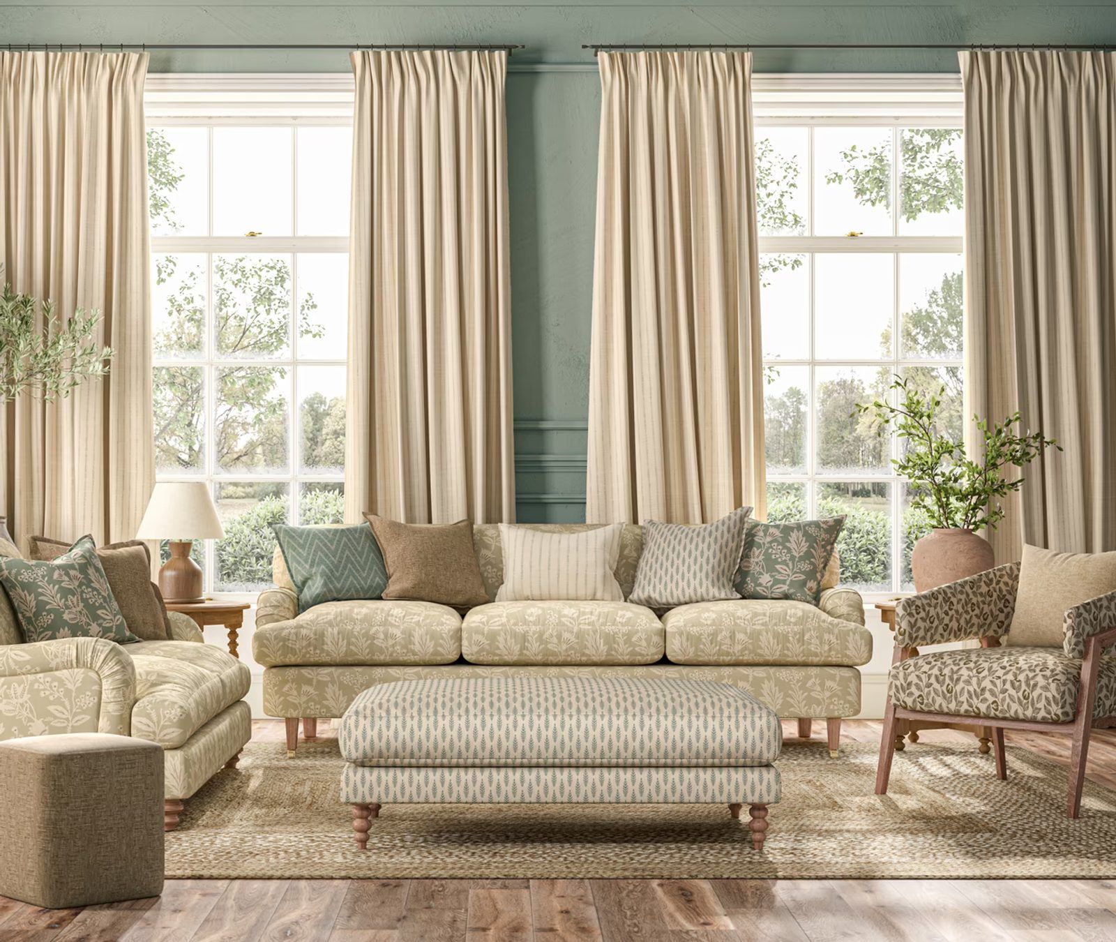Cream pleated curtains at four tall windows in a sage-green living room with patterned sofas