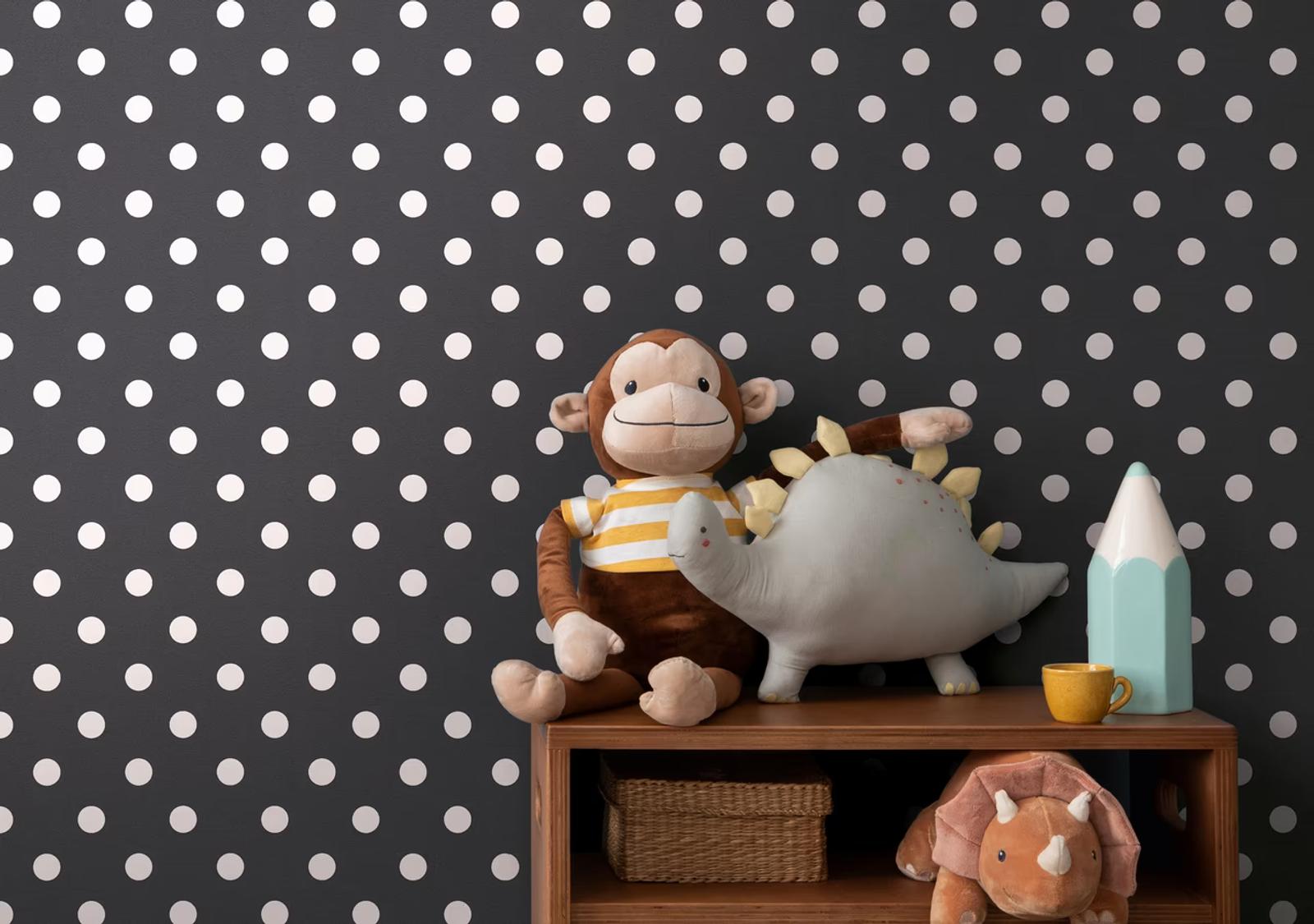 Ink Spot polka dot wallpaper behind a shelf of soft toys