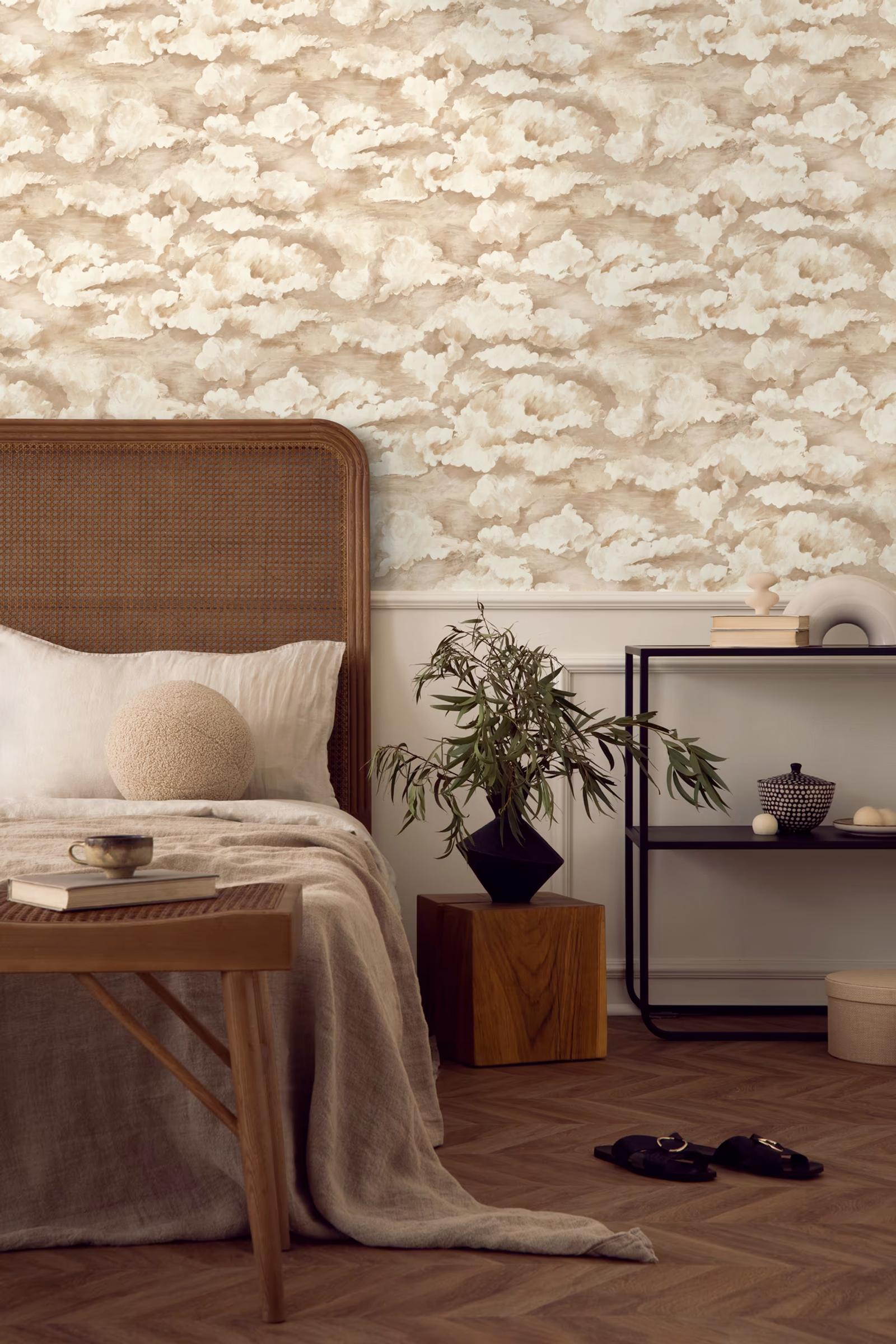 Sora Cream cloud wallpaper in a bedroom with a rattan headboard