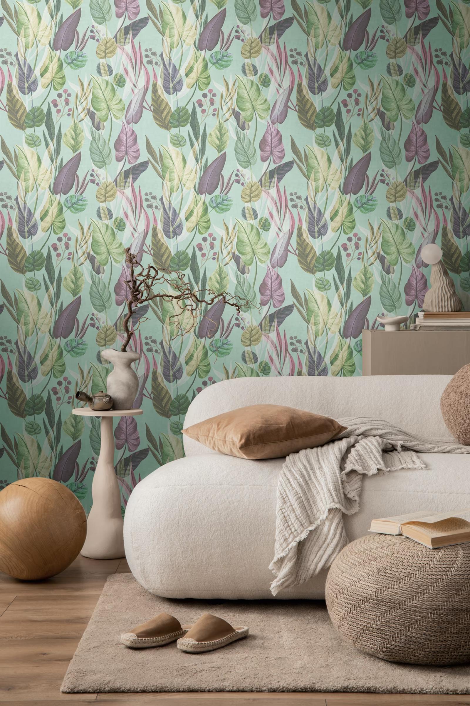 Turquoise Foliage wallpaper behind a bouclé sofa and side table