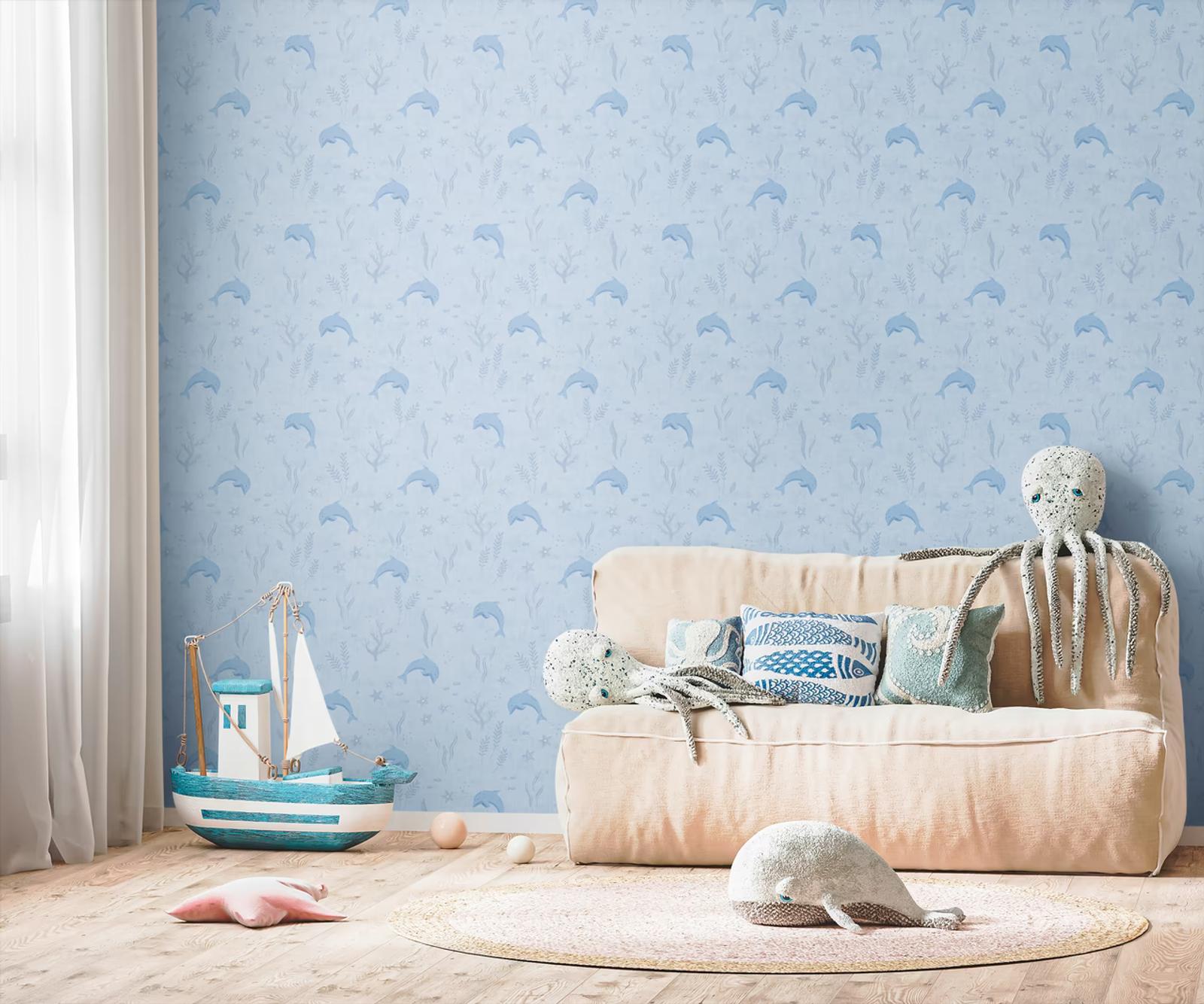 Dolphin Bay wallpaper behind a soft sofa and toy sailing boat