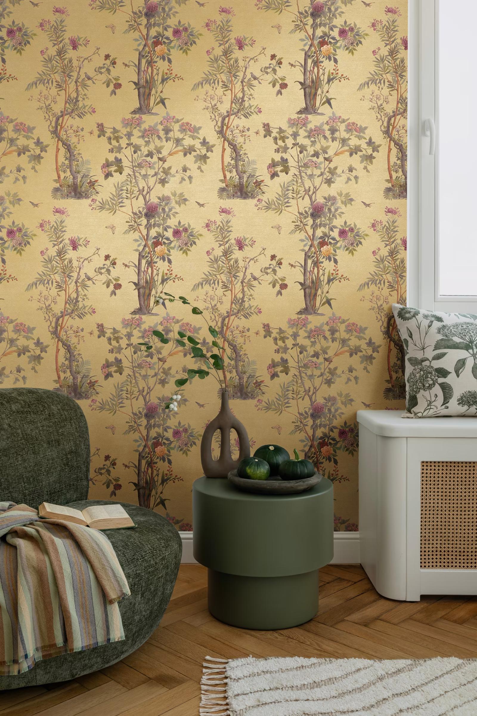 Ochre Chinoiserie wallpaper beside a window with a green armchair