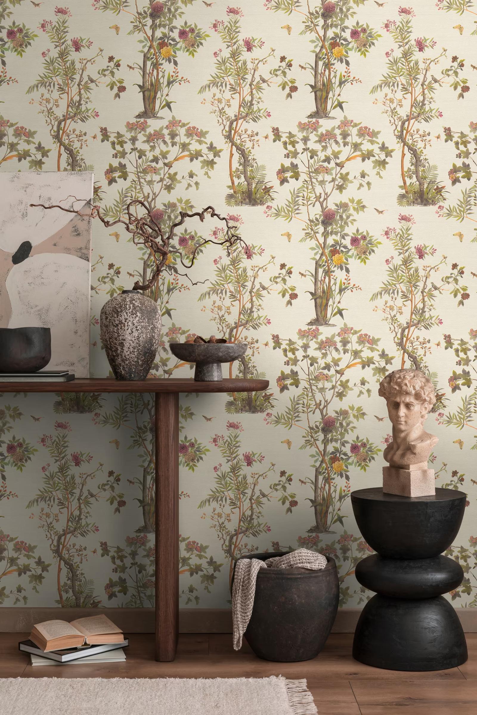 Cream Chinoiserie wallpaper above a dark console with a classical bust