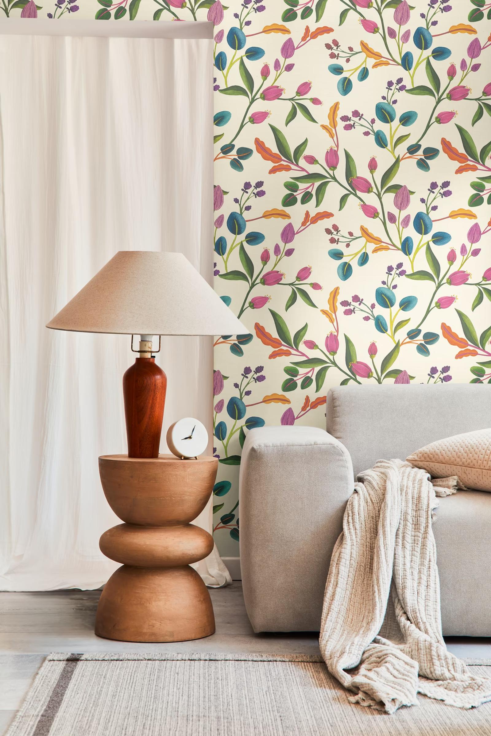Cream Tulipa wallpaper beside a table lamp and linen curtain