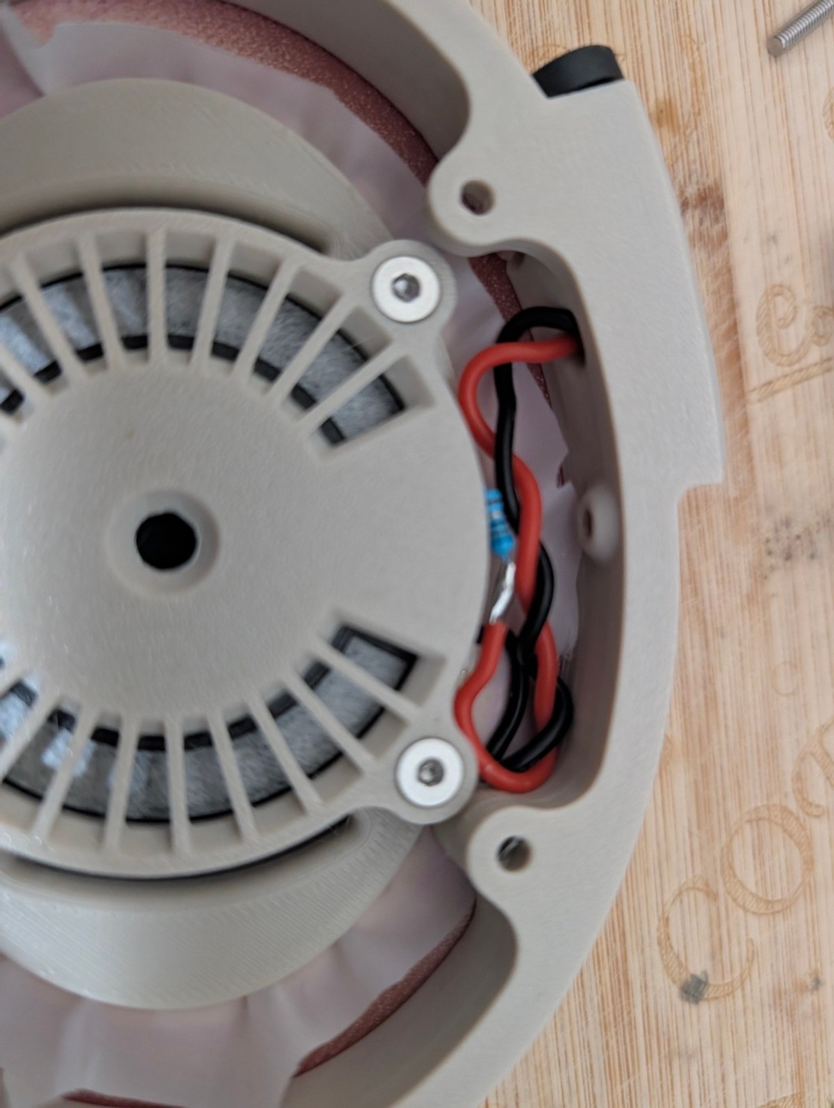 Inside a Satyr 4 cup: the wired driver behind an ivory spoked baffle
