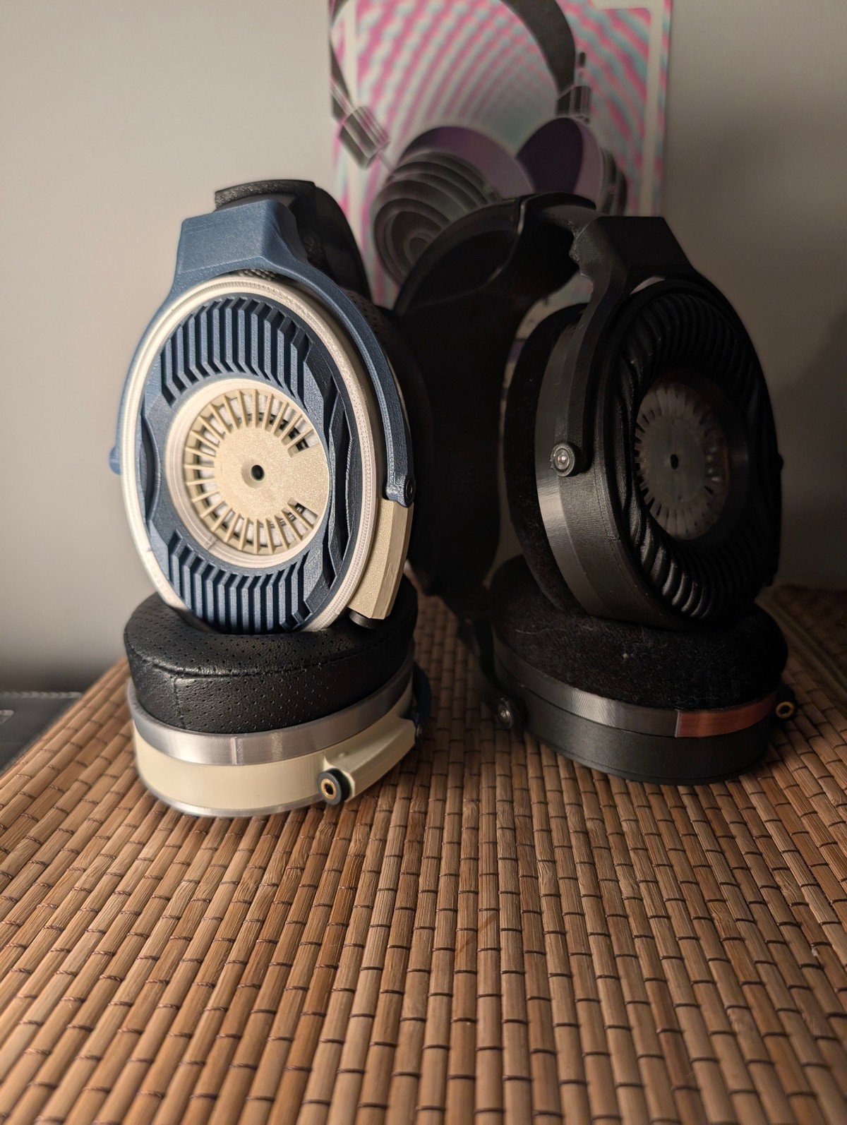 Two Satyr 4 builds side by side, blue and ivory next to black, standing on their pads