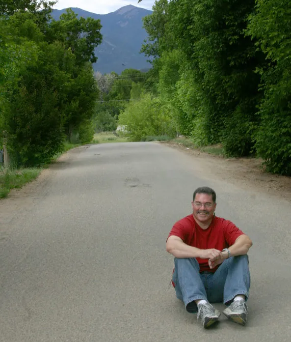 Rich Gallego taking a break from class with Taos Mountain in the background