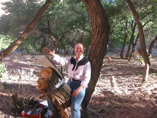 Ursula sketching using a tree notch as an easel.