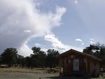 Ranch cabin with wood pile ready for our evening circle.