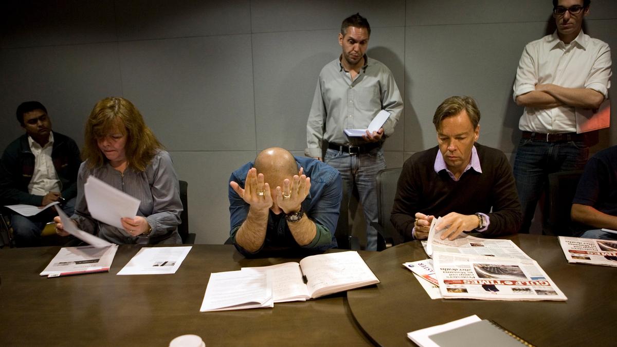 The strain starts to show as Executive Producer Carlos Van Meek (centre) takes morning conference at news channel Al Jazeera English in Doha. Qatar, Doha. 2011