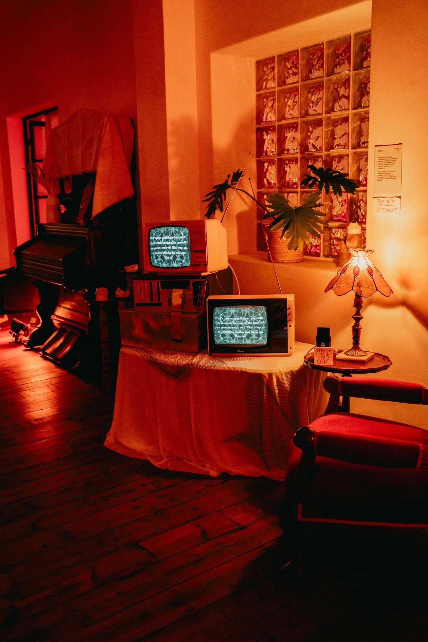 Vintage CRT televisions displaying visuals and text in a warm interior setting