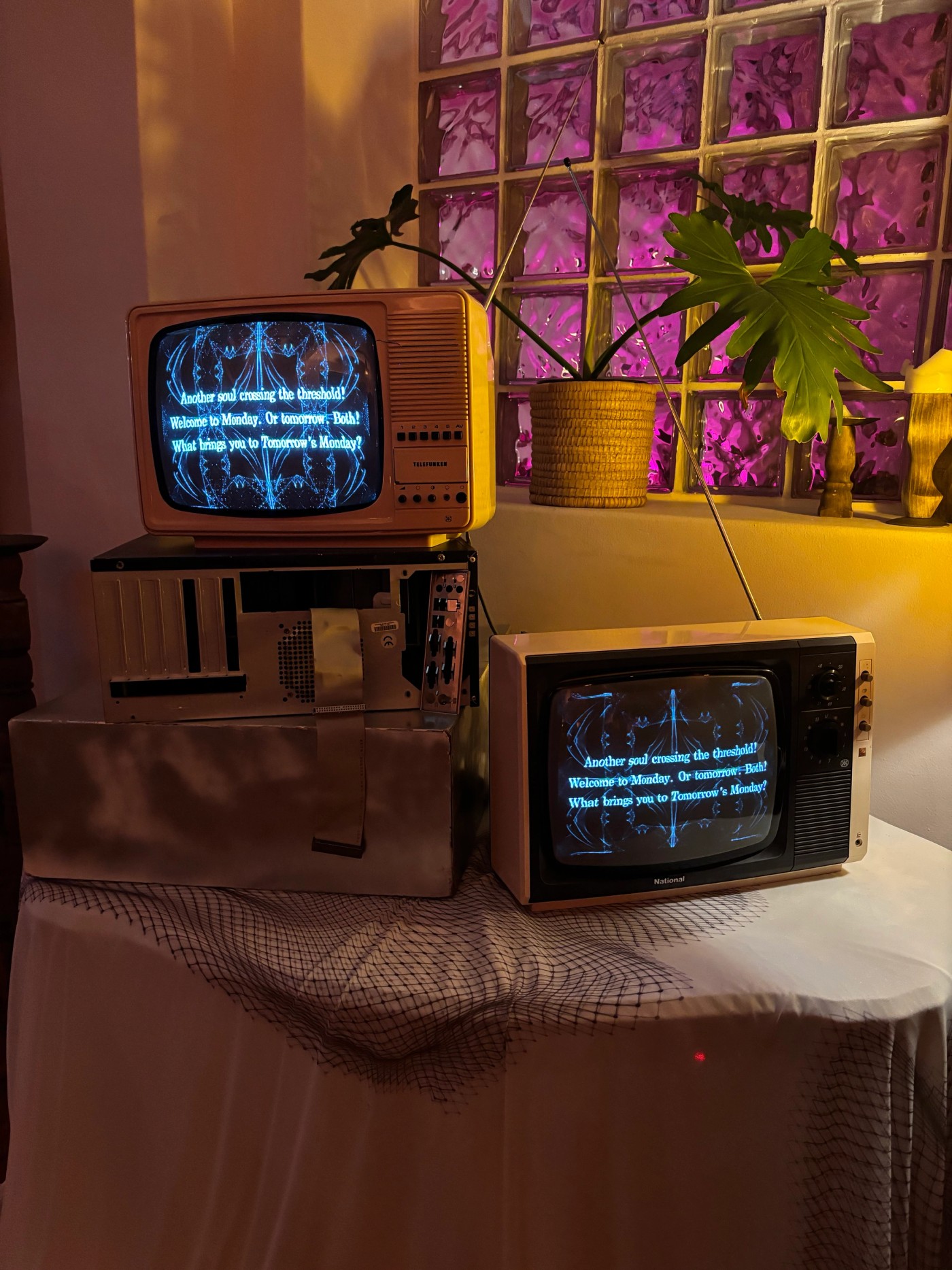 Vintage CRT televisions displaying audio-generative visuals and text in a warm interior setting