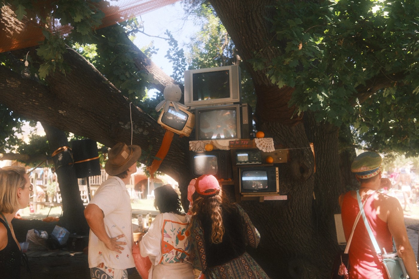 Festival visitors interacting with a CRT TV art installation