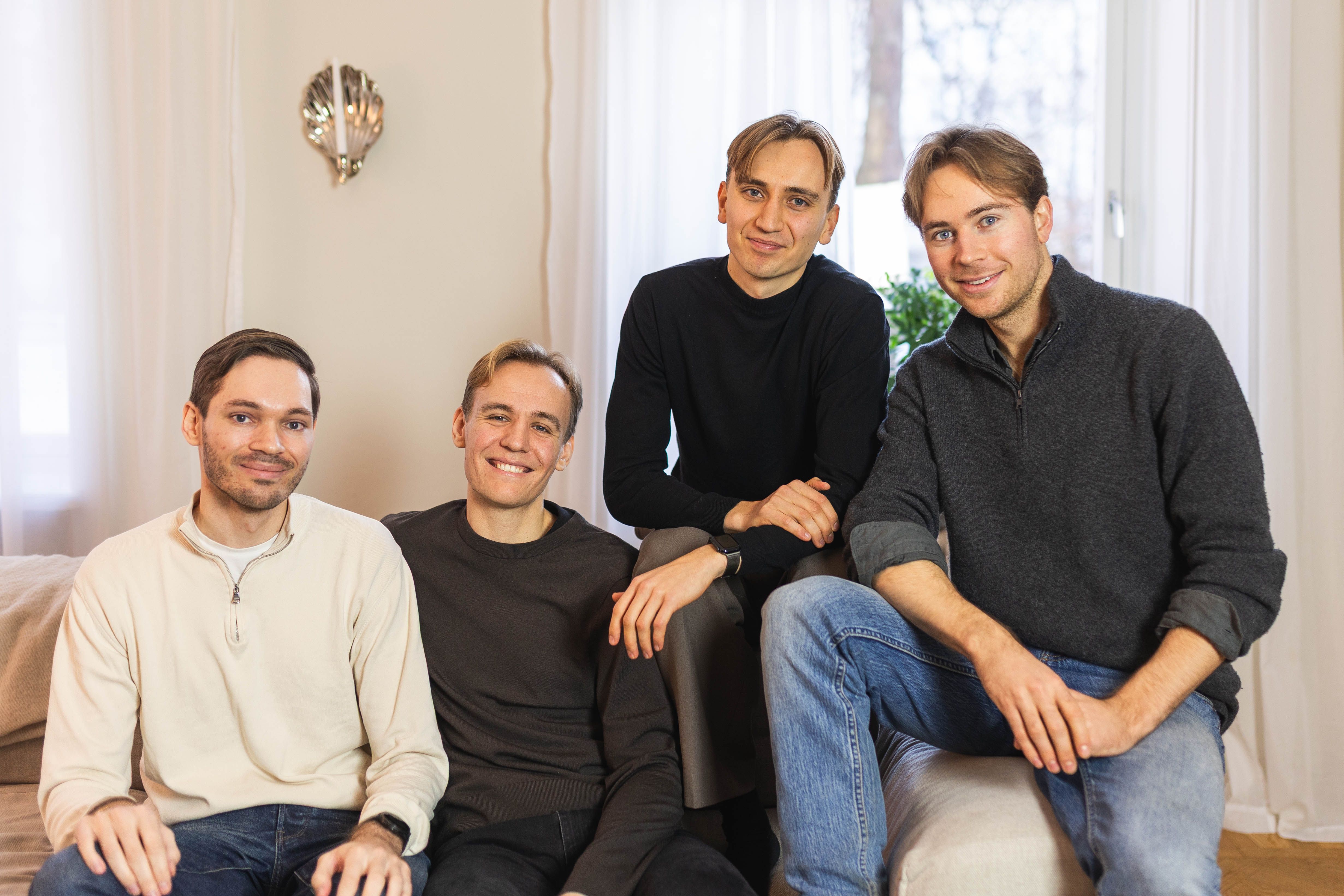 The four Stilta founders seated together on a sofa