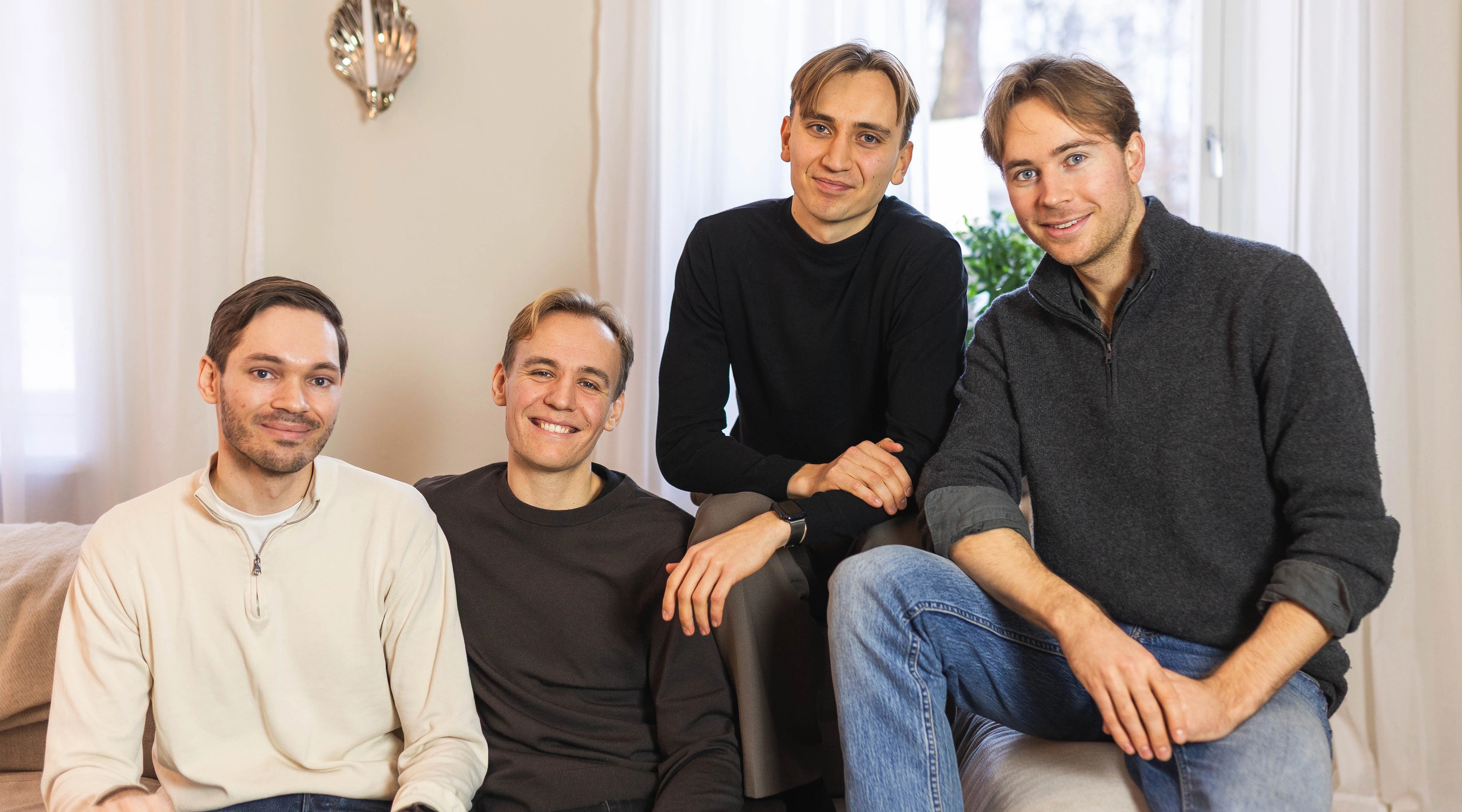 The four Stilta founders seated together on a sofa