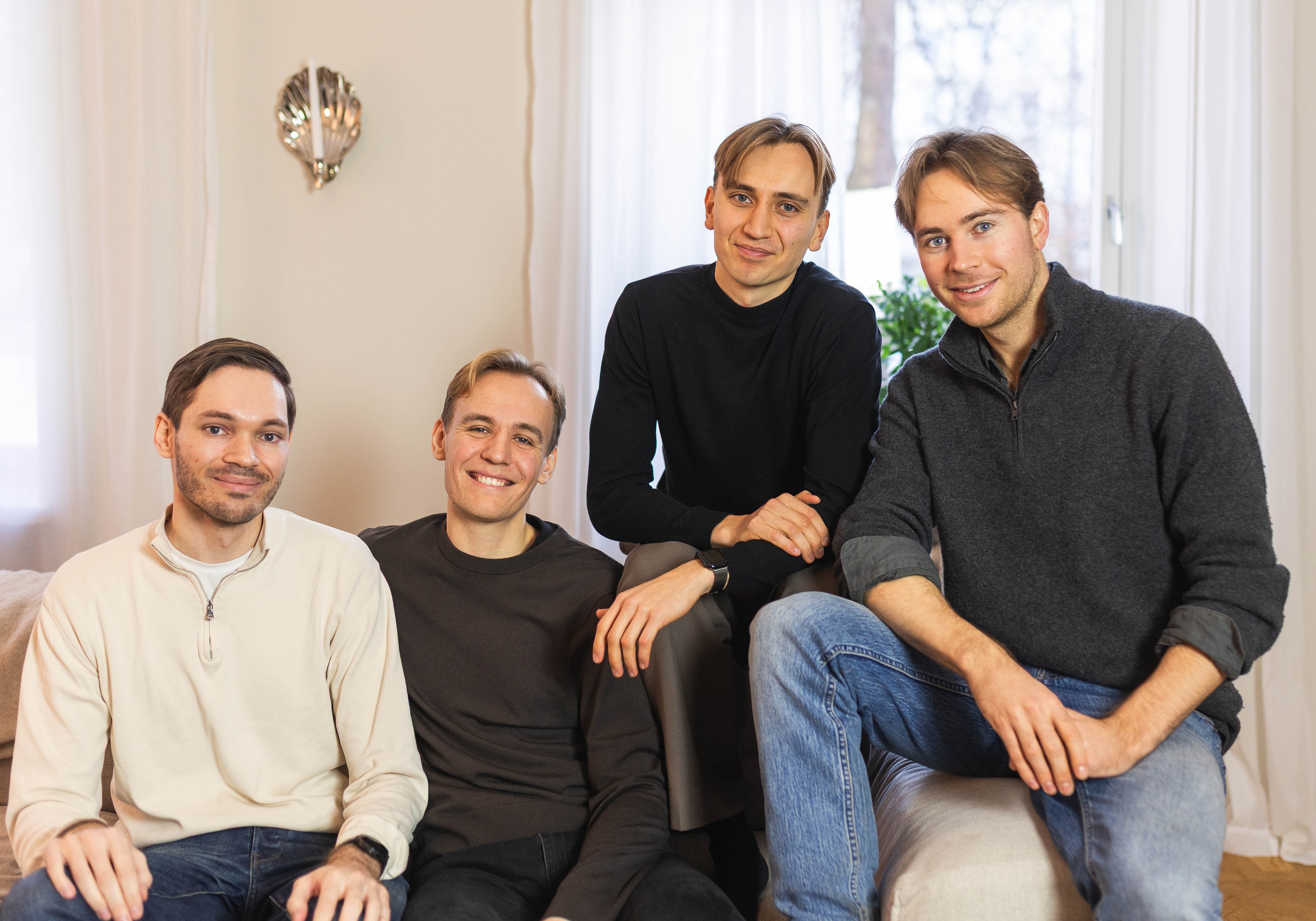 The four Stilta founders seated together on a sofa