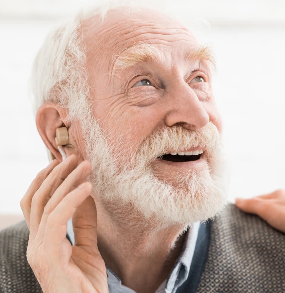 gentleman using an in-the-ear hearing aid
